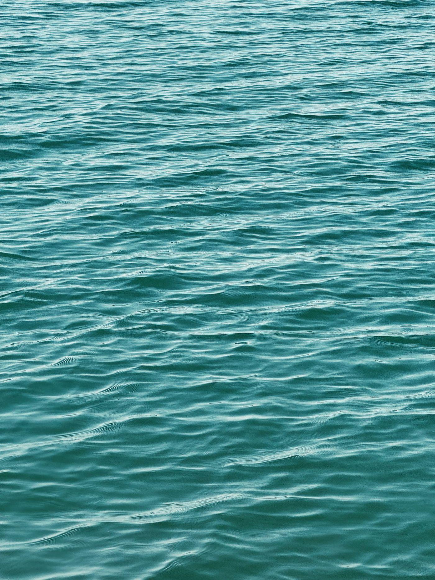 Gentle turquoise ripples running across shallow water